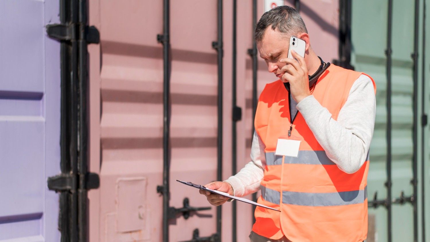 Supply chain professional talking on phone in a container port